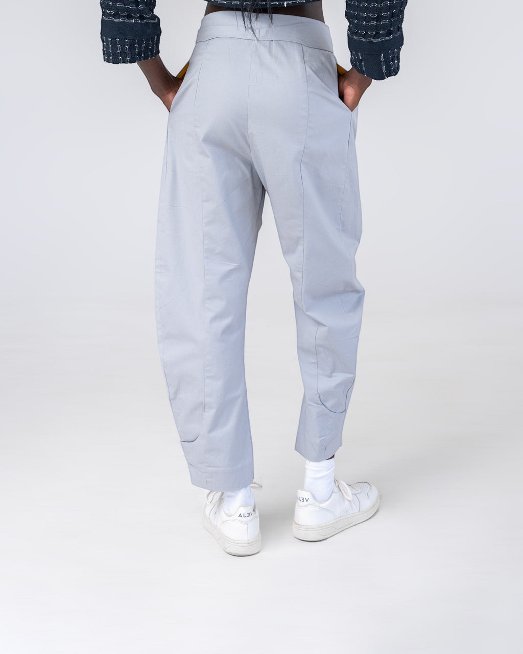 NAMLAB Hobe light grey barrel-legged trousers with a cutout waist feature and cuffed ankles.