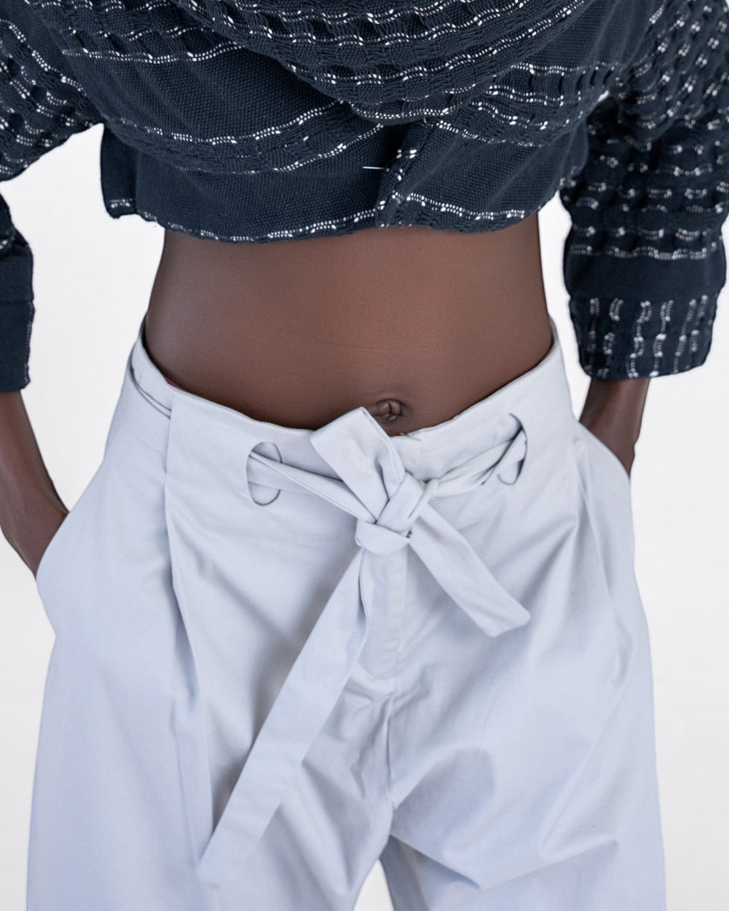 NAMLAB light grey Hobe trousers with a tie waist and cutout detail. Barrel-leg design.